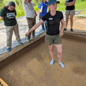 Field School student Janne Wagner explains the north field excavation units to guests and staff during the weekly walkabout.