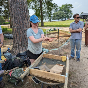 Field School Student Sarah Hespe shares some of the artifacts found at the west "flag" excavations.