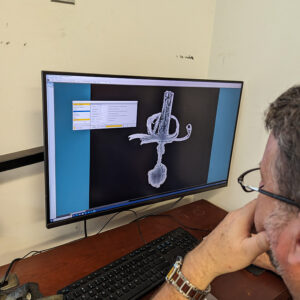 Archaeological Conservator Dr. Chris Wilkins processes an X-ray of one of the swords found in the Governor's Well.