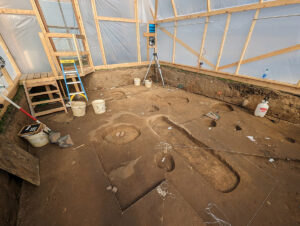 Inside the burial structure. One of the burials is clearly visible, the oblong shape at center.