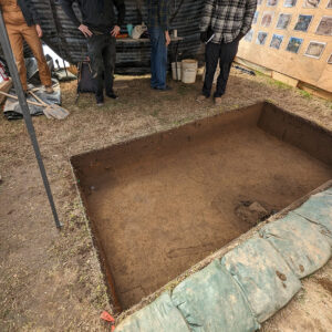 The first archaeological square opened adjacent to the ticketing tent. A delft drug jar can be seen in the top left corner inside a pit or ditch and the edges of four probable burials can be seen along the right side.