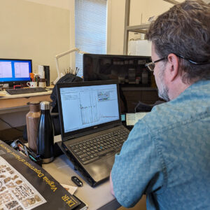 Senior Conservator Dr. Chris Wilkins reviews pXRF results from the flagon found in the Smithfield Well.