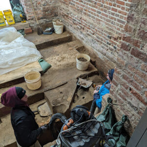 Archaeological Field Technician Ren Willis and Staff Archaeologist Caitlin Delmas at work in the Church Tower.