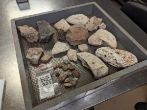 Some of the architectural artifacts found during the Church Tower excavations. Included are examples of granite, quartzite, mortar, and coral.