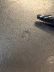 A small faceted gemstone (probably quartz) discovered this month by folks in the Ed Shed picking through objects found in the fort's first well. Its small size suggests it was probably part of a ring (ball-point pen for scale).