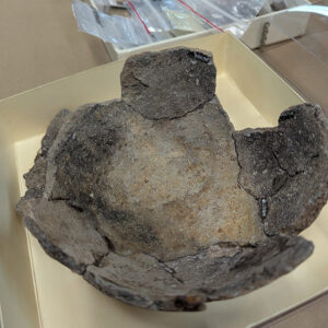 A partially mended Native ceramic vessel. Curatorial intern Molly Morgan is looking for additional sherds that mend to this object.