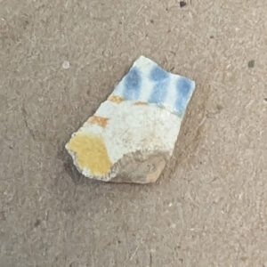 A sherd of delftware found in the cellar excavations. This may belong to a partial cat jug already in the collection.