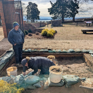 Staff Archaeologist Caitlin Delmas and Archaeological Field Technician Katie Griffith at work in the excavations near the Colonial Dames of America gate.