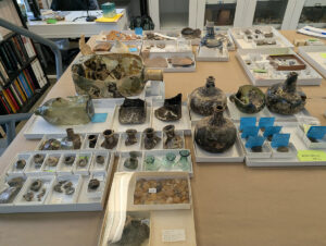 Some of the glass artifacts Senior Curator Leah Stricker has gathered for consideration while creating the glass reference collection