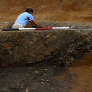Archaeologist excavating a well