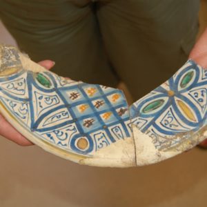 Mended ceramic dish sherds with painted decoration