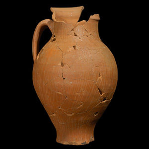 Mended red earthenware jug with handle