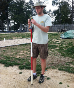 man standing with a stadia rod