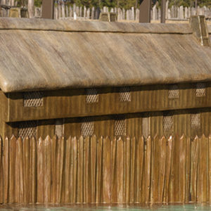 Model of rectangular wooden buildings with thatch roofs