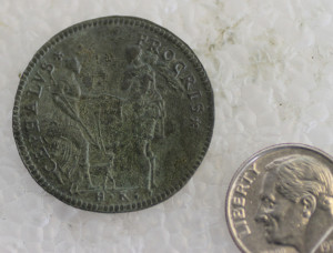 Jetton next to a dime for scale