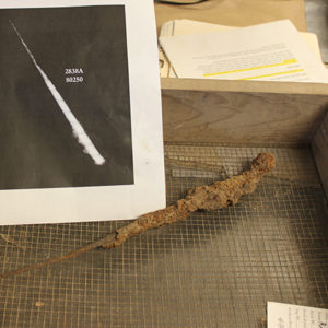 tray with a corroded dagger blade and a print-out of its x-ray
