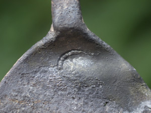 Close-up of a crescent-shaped maker's mark on the top of a spoon bowl