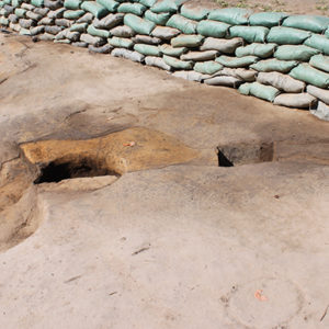 Features within a large excavation unit lined with sandbags