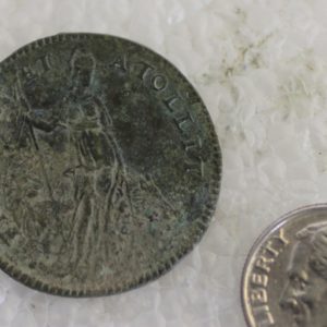 Jetton next to a dime for scale