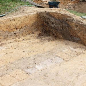 corner of an excavation unit showing a variety of soil stains