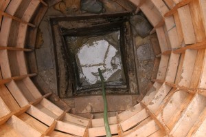 Excavated square well inside of a circular wooden support structure