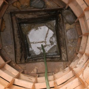 Excavated square well inside of a circular wooden support structure