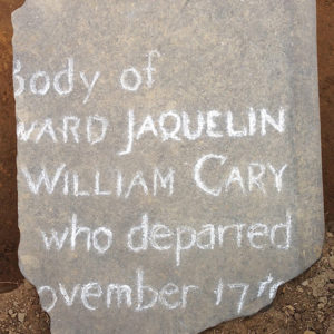 tombstone fragment with inscribed white letters