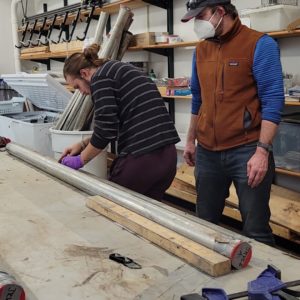 Dr. Ouimet and undergraduate student Preston Senderoff mark one of the Jamestown cores for splitting.