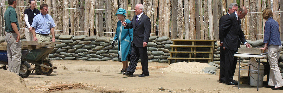 Suited man walking with Queen