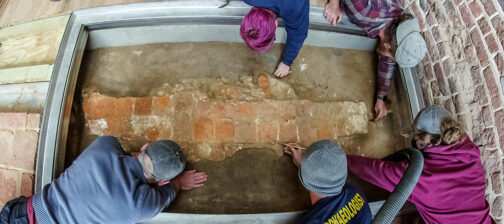 The archaeological team does the final excavations of the 1617 church foundations prior to the installation of the glass portal.