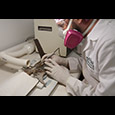 Director of Collections and Conservation Michael Lavin uses air abrasion to remove corrosion from the halberd.