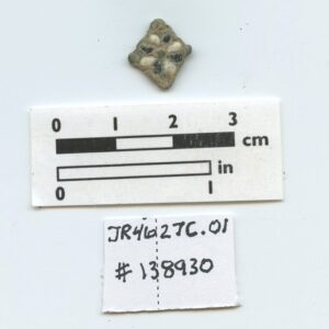 Copper alloy decorative object (likely a jewelry link) before conservation