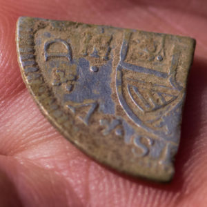Hand holding a quartered coin