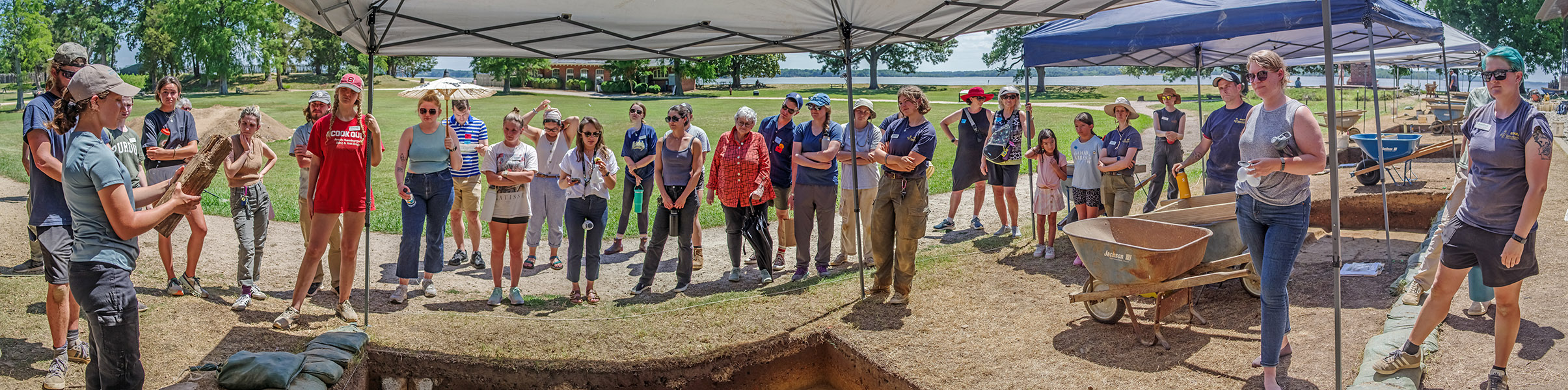 Field school student Julia Womersley-Jackman holds a 20th-century signpost found in her excavation square during the weekly walkabout.