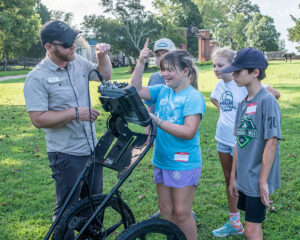 Director of Archaeology Sean Romo teaches campers how to use the ground-penetrating radar (GPR) machine.