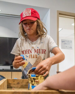 A camper mends a reproduction ceramic vessel.