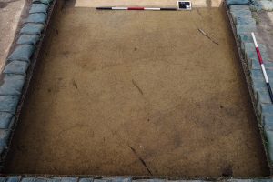 Two burials found just south of the Archaearium are distinguished by their oblong shape and darker soil than that of the surrounding area.